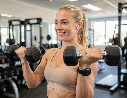 Woman Performing Dumbbell Press