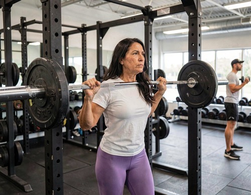Woman Preparing for Barbell Press