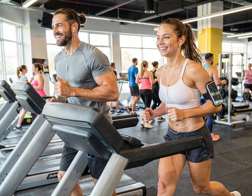Couple Running on Treadmills