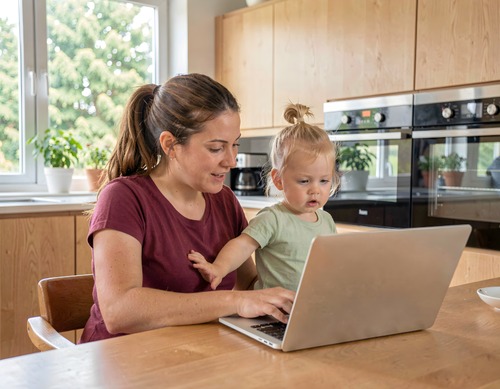 Mother and Child Using Laptop at Home