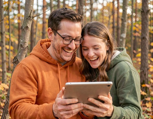 Couple Sharing Tablet in Forest
