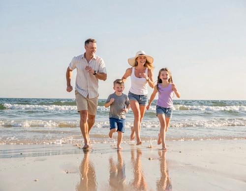 Happy Family Running on Beach
