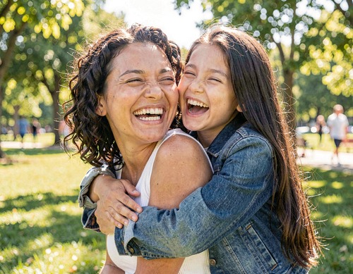 Mother and Daughter Laughing in Park