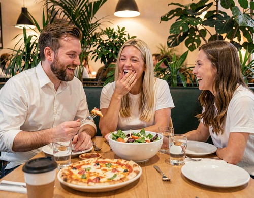 Friends Laughing Over Dinner