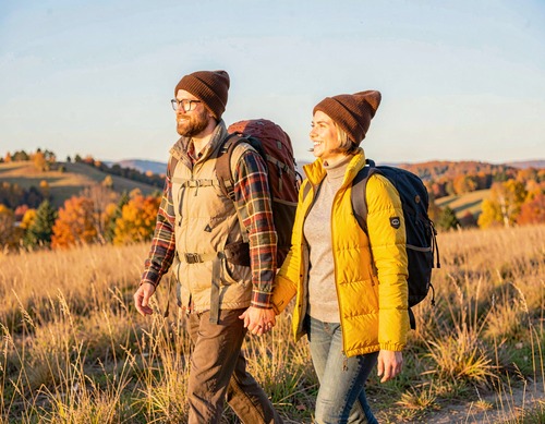 Hiking Couple in Autumn Fields