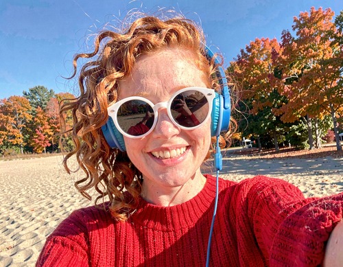 Happy Woman with Headphones Outdoors