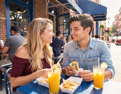 Couple Enjoying Tacos at Outdoor Cafe