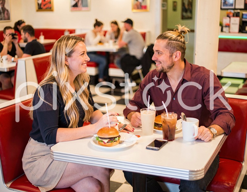 Diner Friends Laughing Over Burgers
