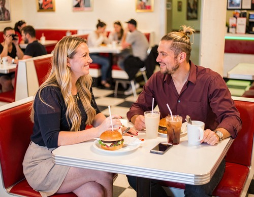Diner Friends Laughing Over Burgers