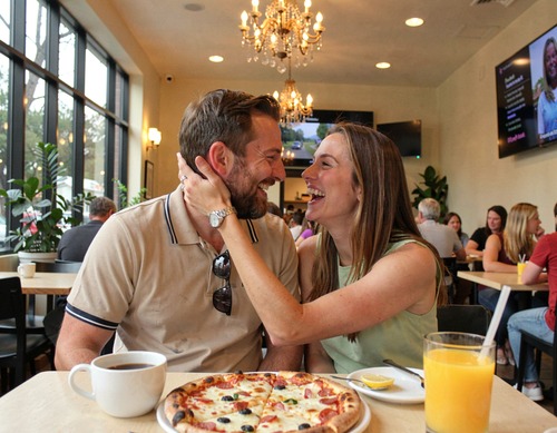 Happy Couple Laughing in Café