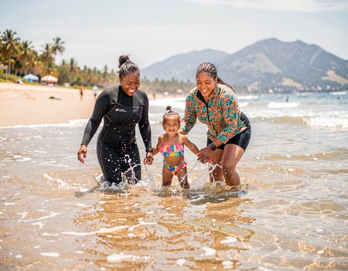 Happy Family Playing in the Ocean