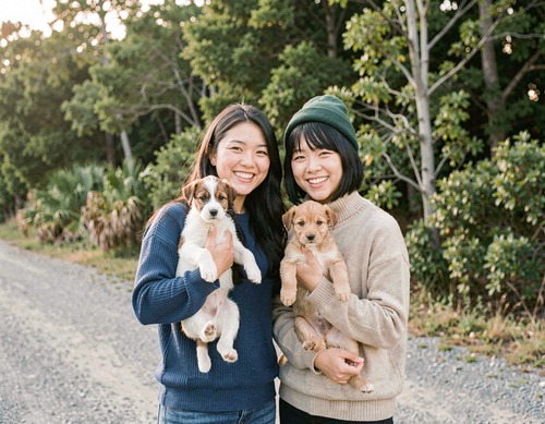 Women with Puppies Outdoors