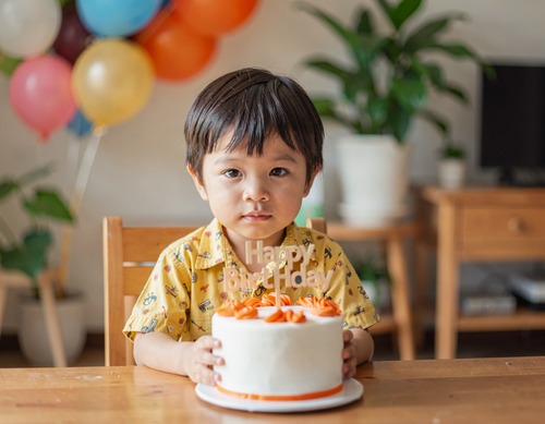 Child Holding Birthday Cake Topper