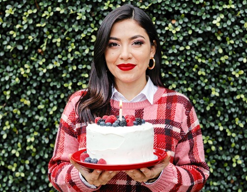Woman Blowing Out Birthday Candle