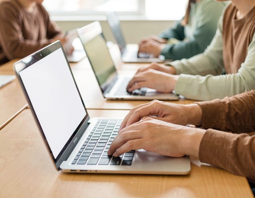Students Typing on Laptops