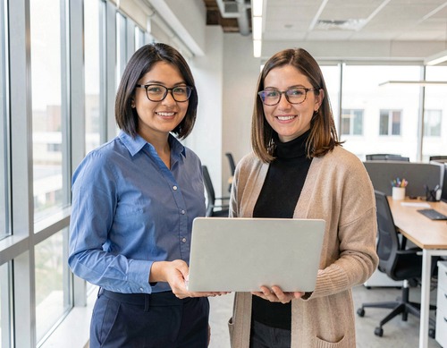 Two Women Collaborating on Laptop