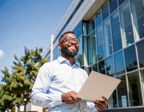 Confident Businessman with Laptops