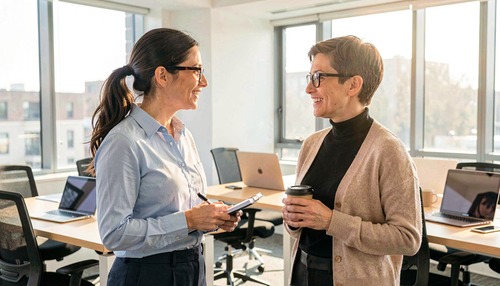 Two Women Discussing in Office