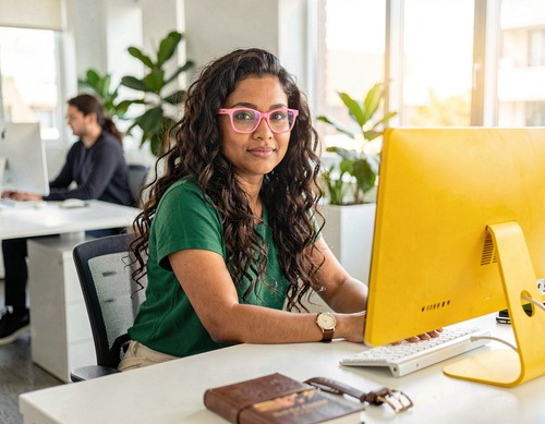 Office Worker at Desk with Plants
