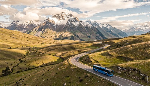 Winding Mountain Road with Snow-Capped Peaks