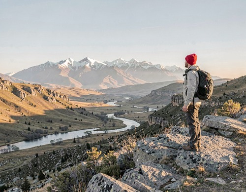 Hiker on Mountain Peak at Sunset
