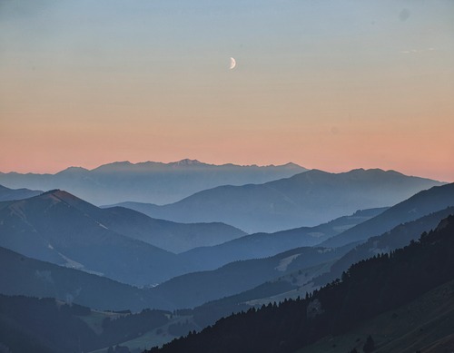 Sunset Mountain Silhouettes with Crescent Moon