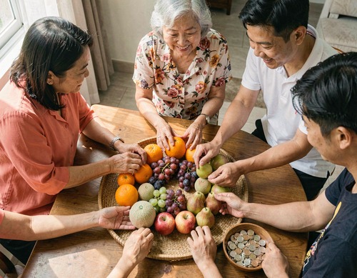 Filipino Family Arranging Twelve Round Fruits