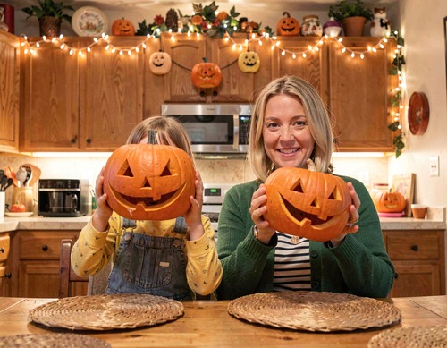 Mother and Child Carving Pumpkins for Halloween