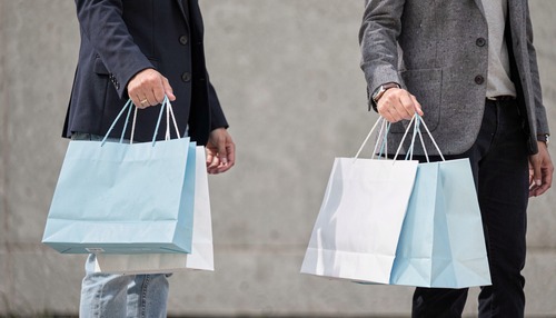 Two People Holding Light Blue Shopping Bags