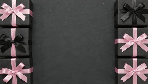 Black Gift Boxes with Pink Ribbons Arranged on Dark Background