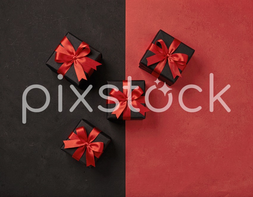 Black Gift Boxes with Red Ribbons on Split Background