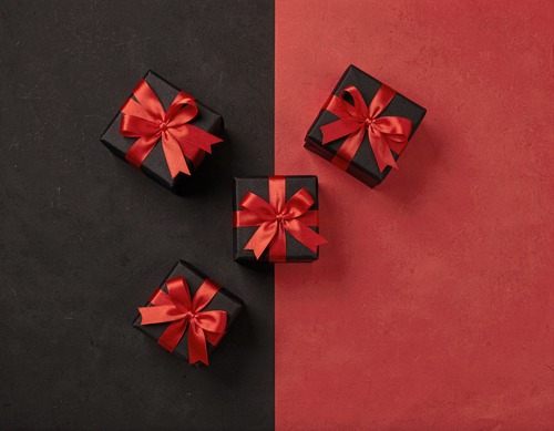 Black Gift Boxes with Red Ribbons on Split Background