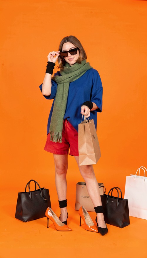 Woman in Green Scarf on Orange Background