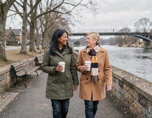 Two Women Friends Walking River Path With Coffee