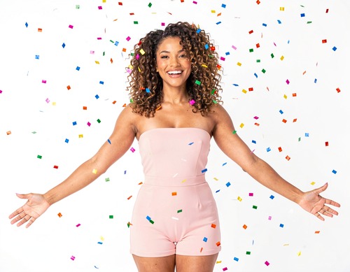 Woman with Curly Hair Celebrating with Confetti